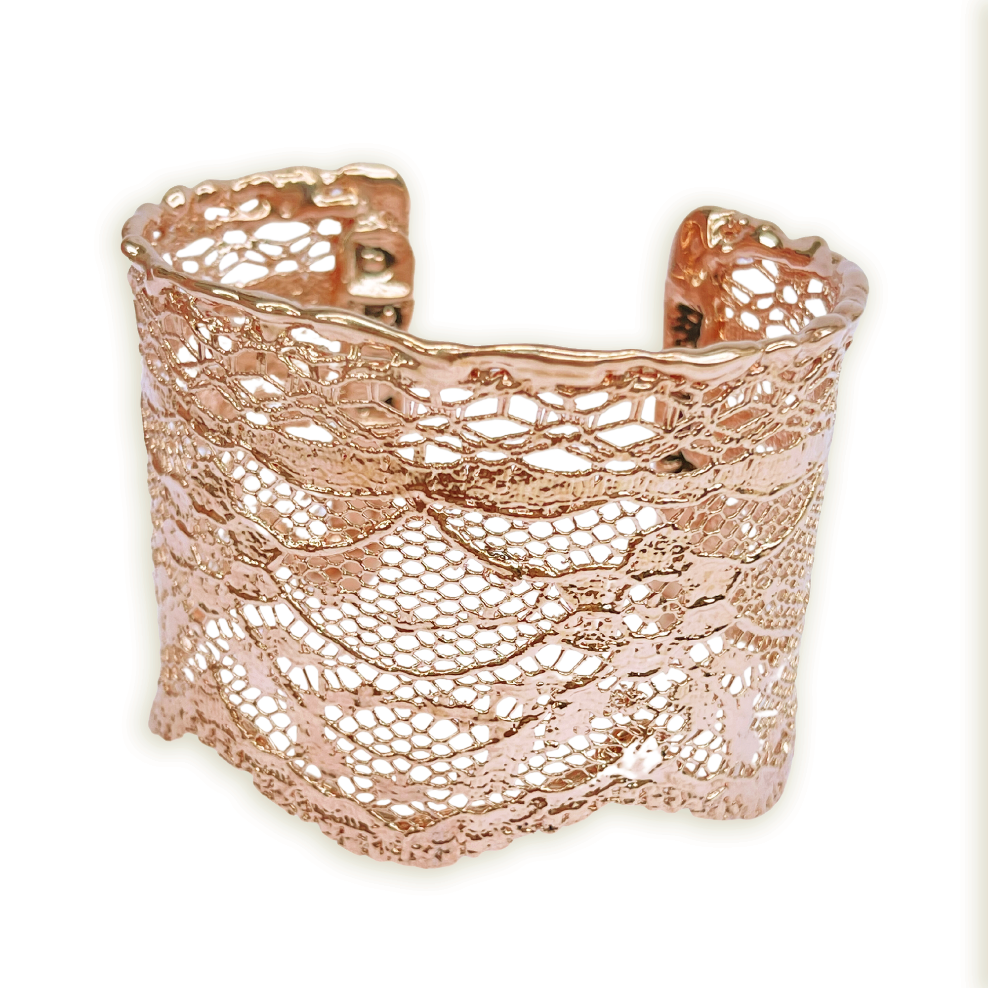 Intricate lace cuff bracelet in rose gold.