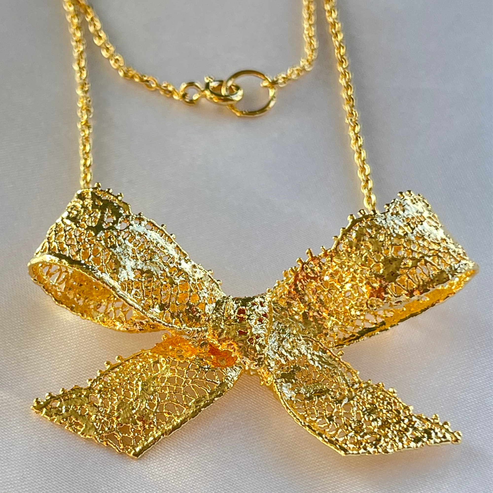 Micheline Lace Bow Necklace in 24k gold.