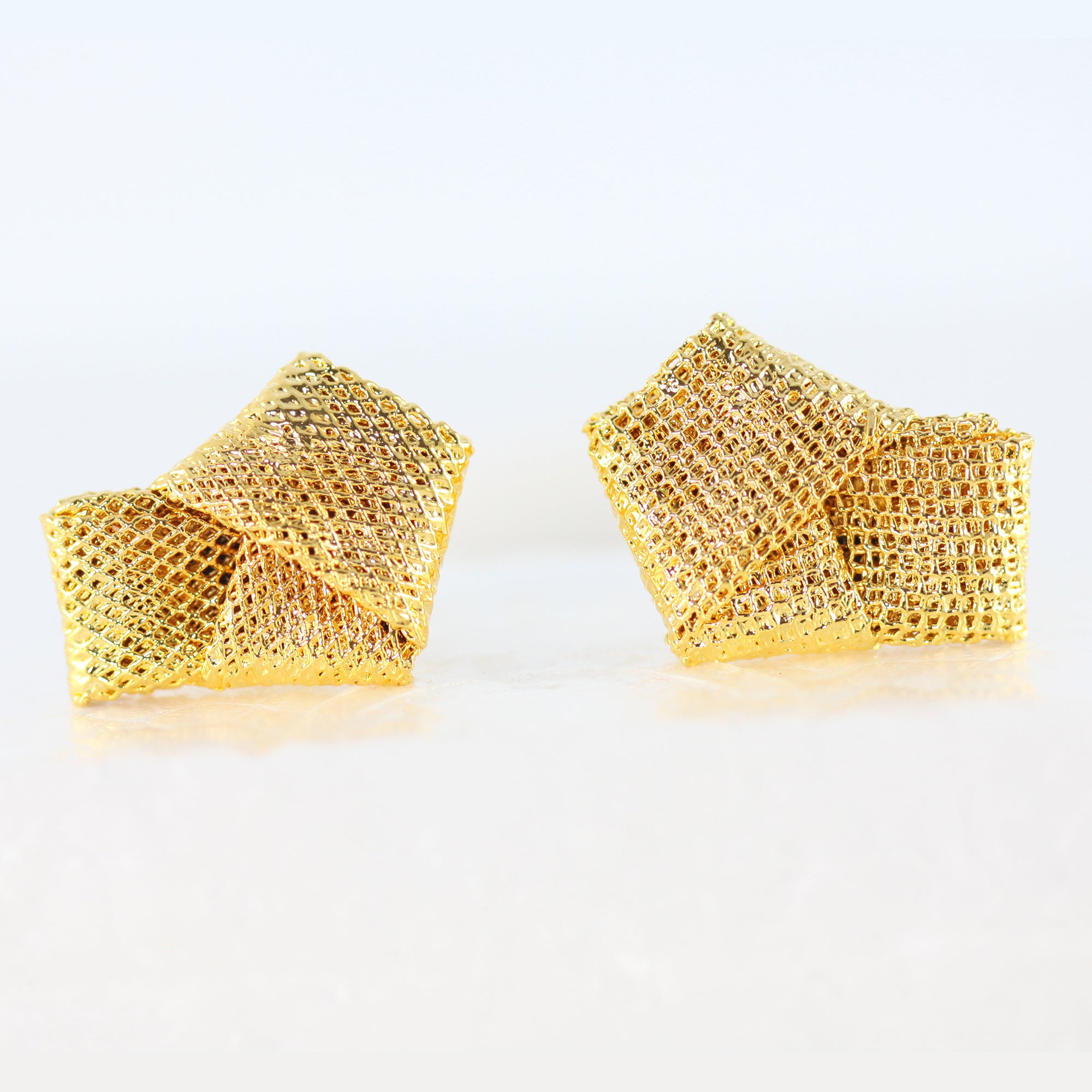 Cufflinks made from wedding dress tulle tied in a knot and dipped in 24k gold.