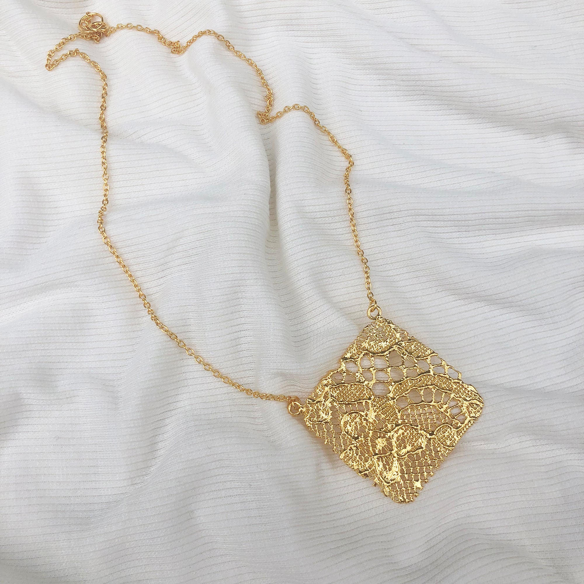 Intricate square pendant lace necklace in 24k gold.