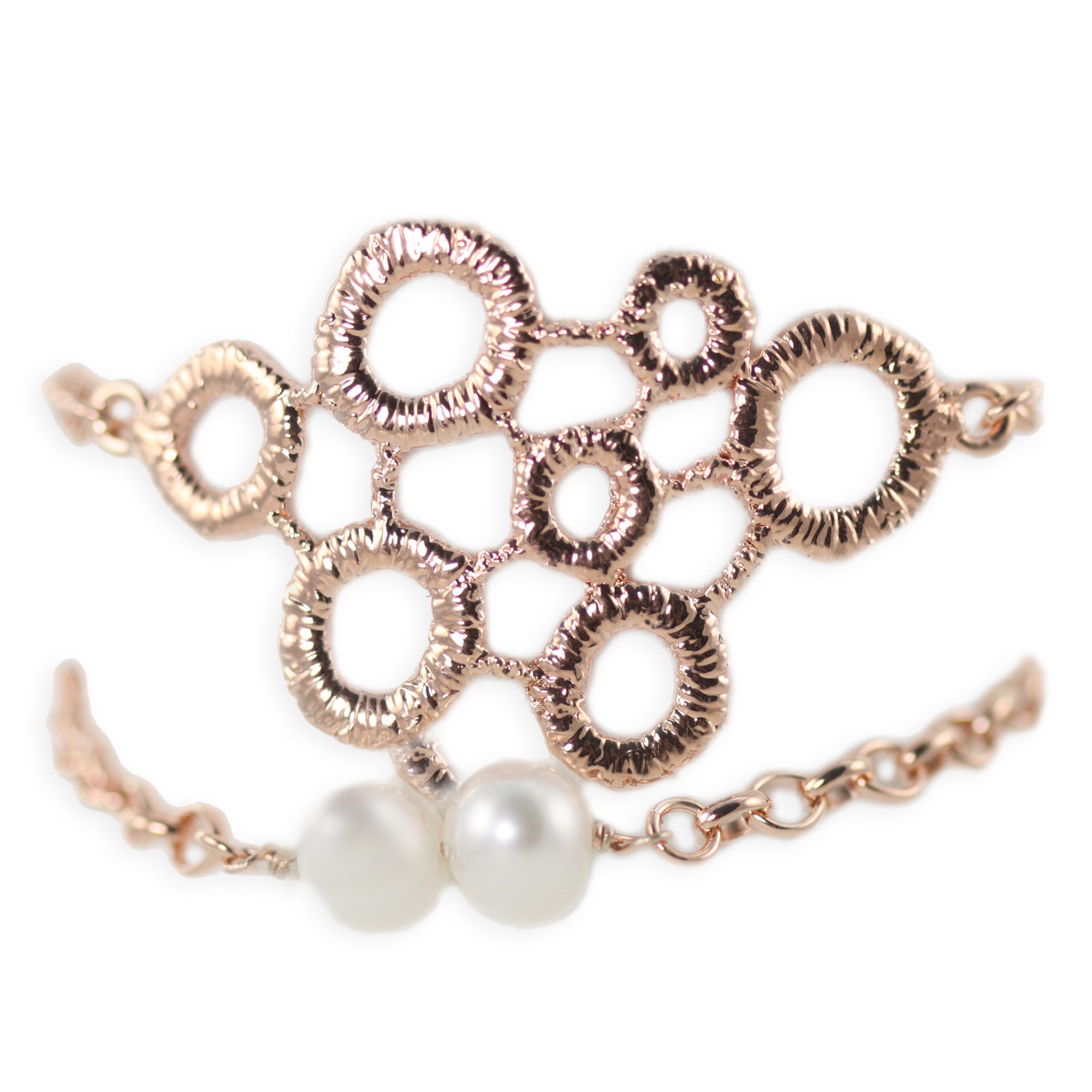 Exquisite chain bracelet with two pearls and a circular lace front dipped in rose gold.