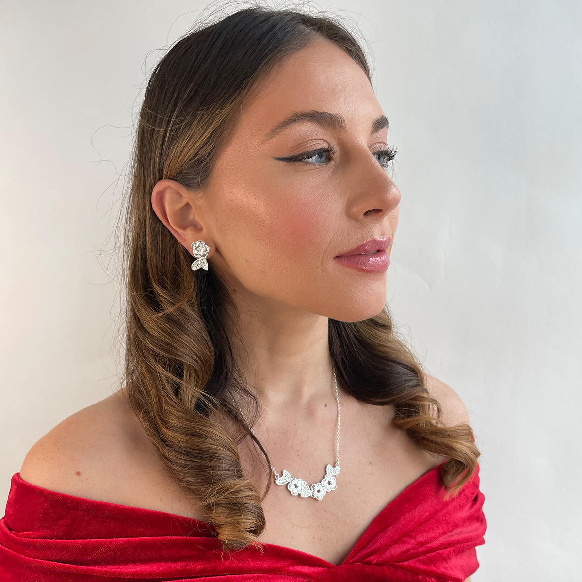 Ella lace earrings and Ellinor lace necklace in sterling silver on a model.