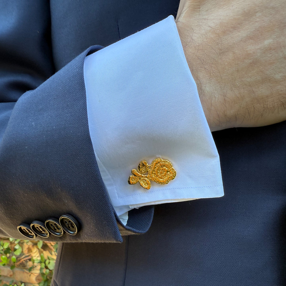 Model wearing the Albie lace rose cufflinks in 24k gold.