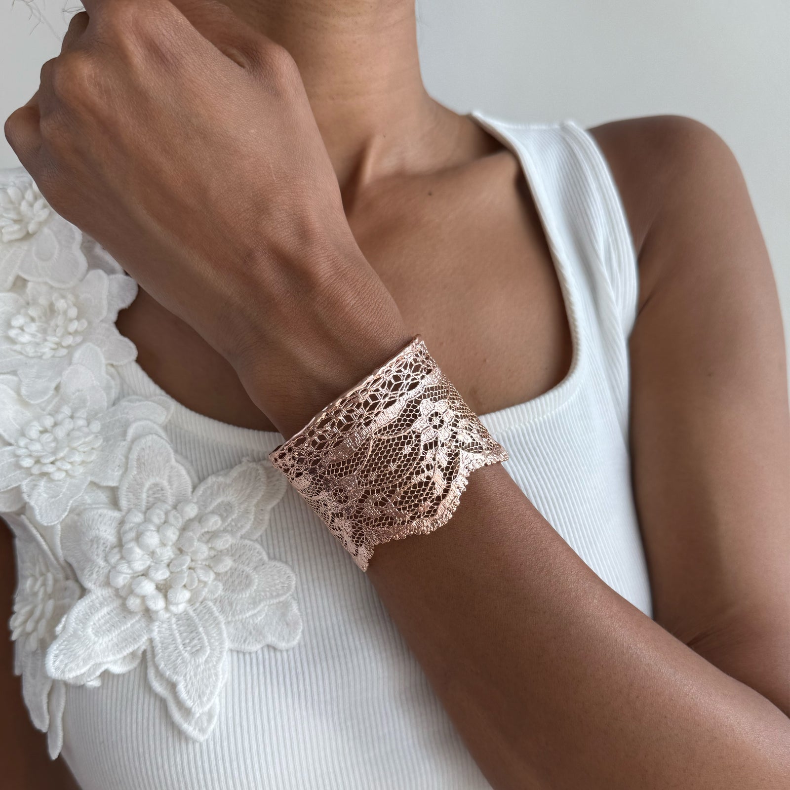 Intricate lace cuff bracelet in rose gold.