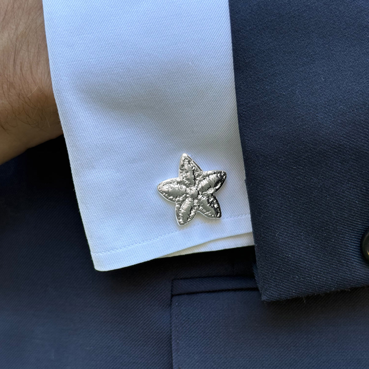 Model wearing the Felix lace star cufflinks in Sterling Silver.