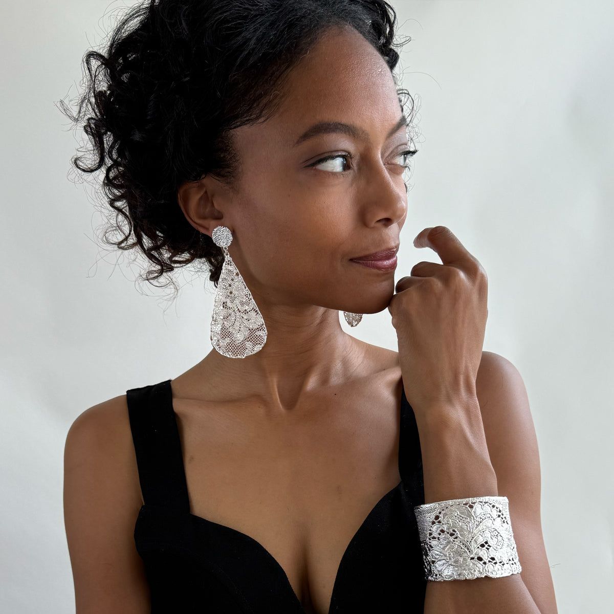 Model wearing Leopoldine lace earrings in sterling silver.