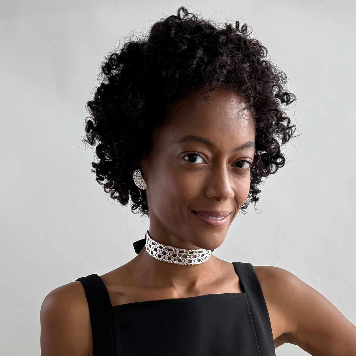 Model wearing a French lace choker in sterling silver with velvet ribbons.