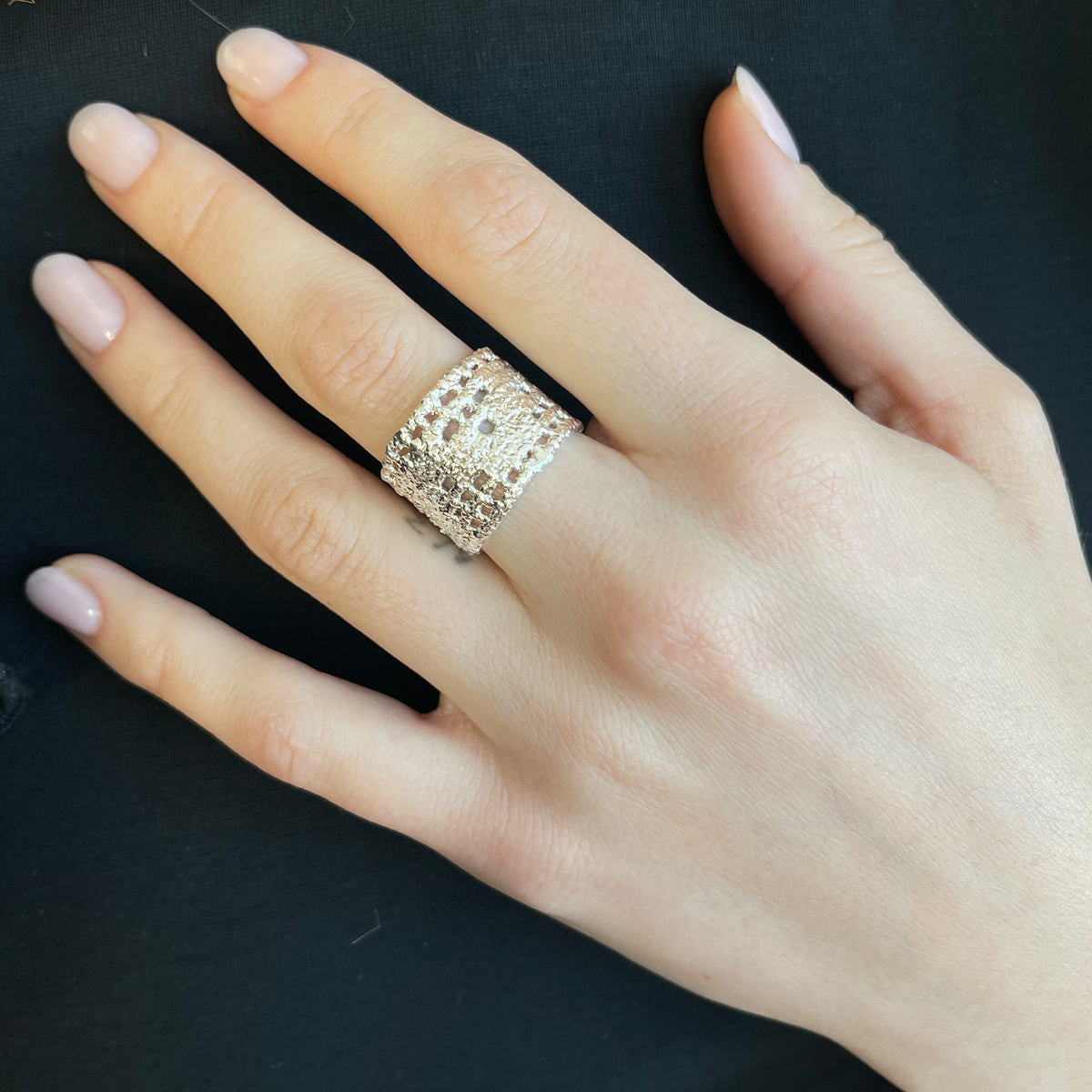 Model wearing textured lace ring in sterling silver.