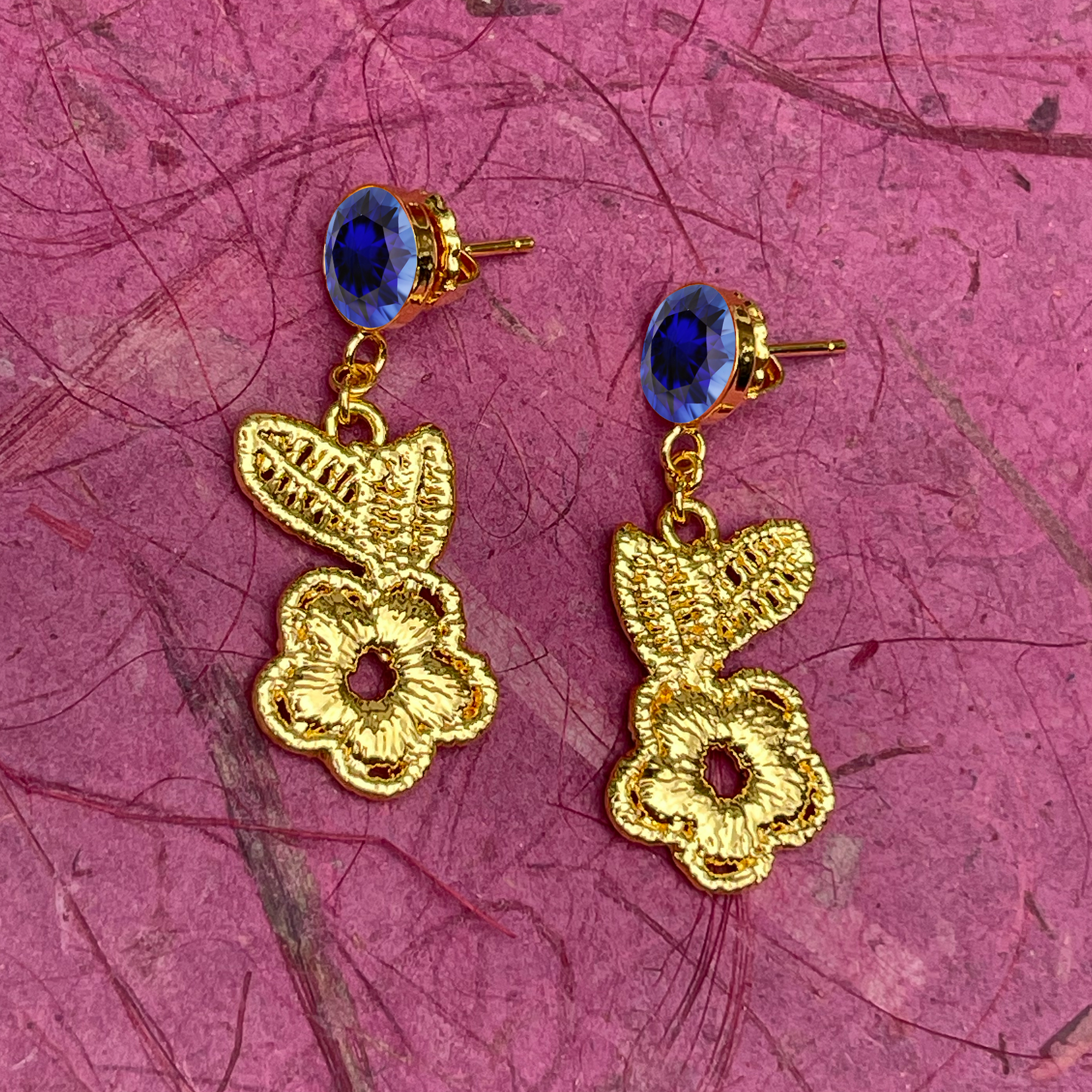 Flower lace earrings in 24k gold with blue sapphires.