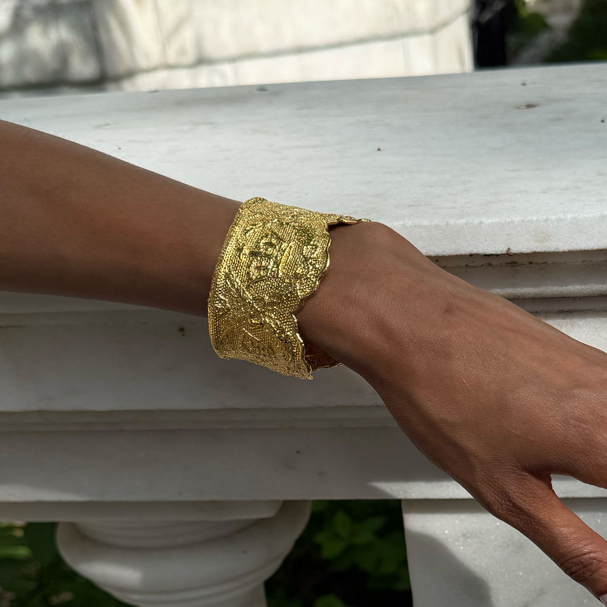 Model wearing lace cuff bracelet Margaret Rose in 24k gold made with British royal lace.