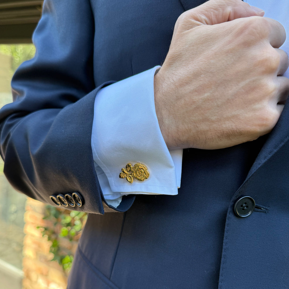 Model wearing the Albie lace rose cufflinks in 24k gold.