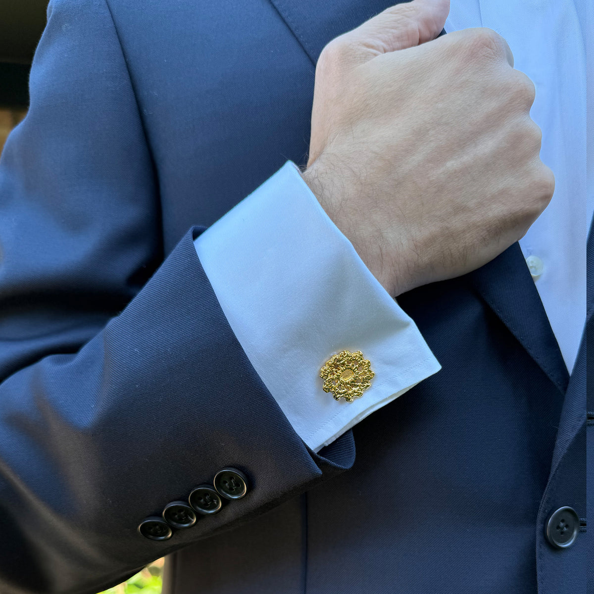 Model wearing  the Emil cufflinks made from Swedish lace dipped in 24k gold.