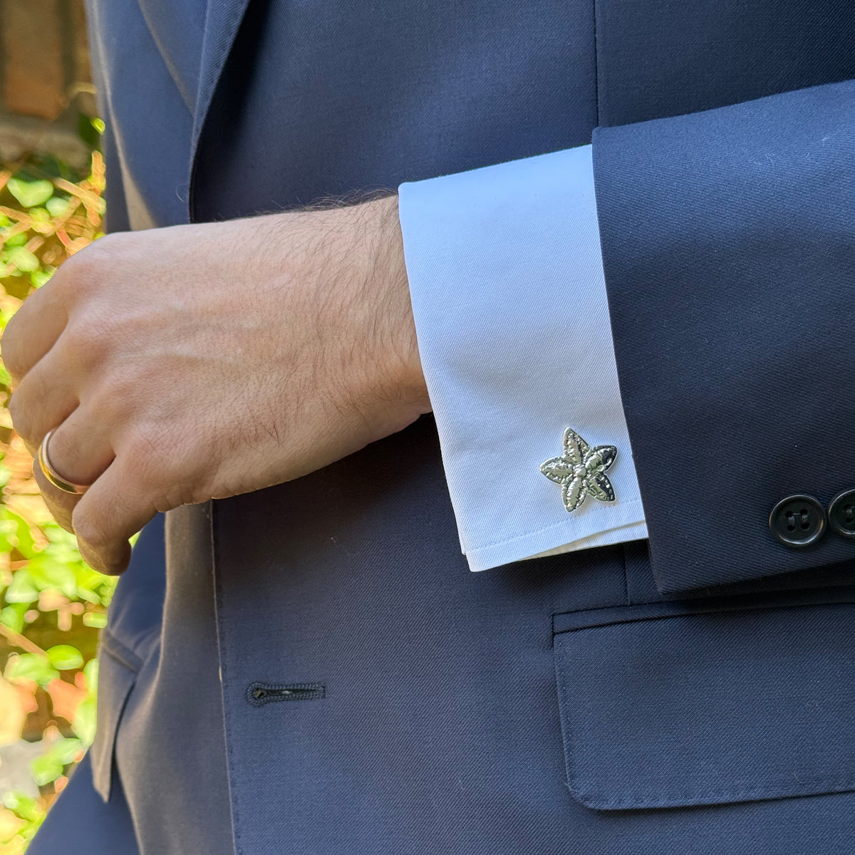 Model wearing the Felix lace star cufflinks in Sterling Silver.
