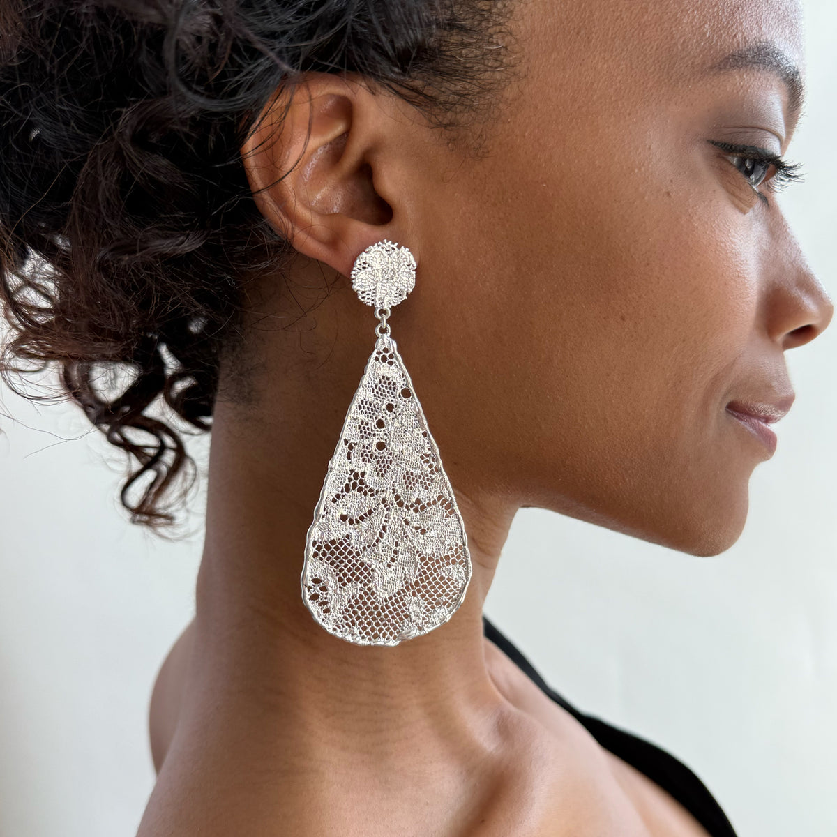 Model wearing Leopoldine lace earrings in sterling silver.