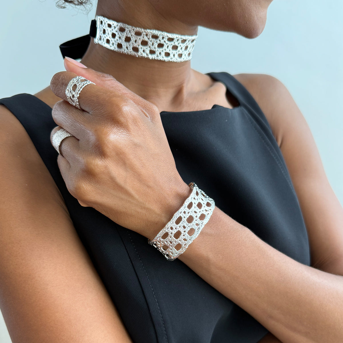 Model wearing French lace cuff bracelet dipped in sterling silver and a lace silver choker.