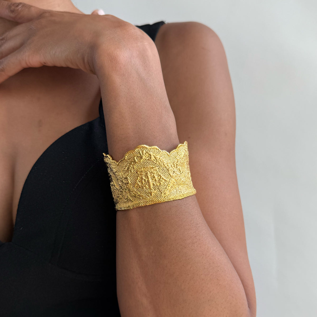 Model wearing lace cuff bracelet Margaret Rose in 24k gold made with British royal lace.