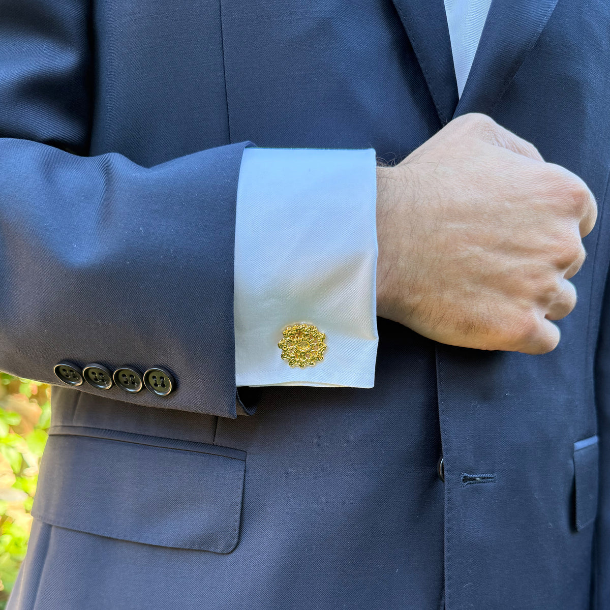 Model wearing  the Emil cufflinks made from Swedish lace dipped in 24k gold.