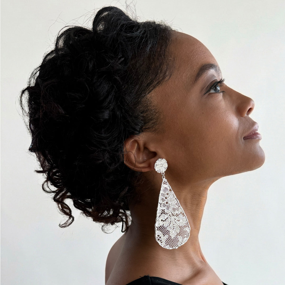 Model wearing Leopoldine lace earrings in sterling silver.