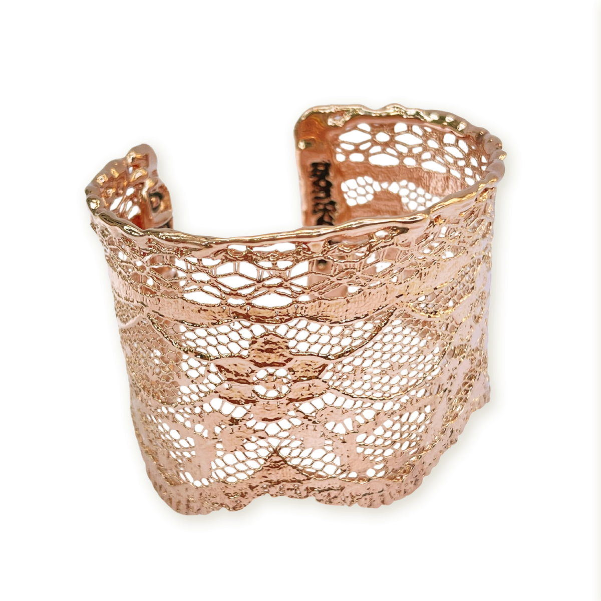 Intricate lace cuff bracelet in rose gold.