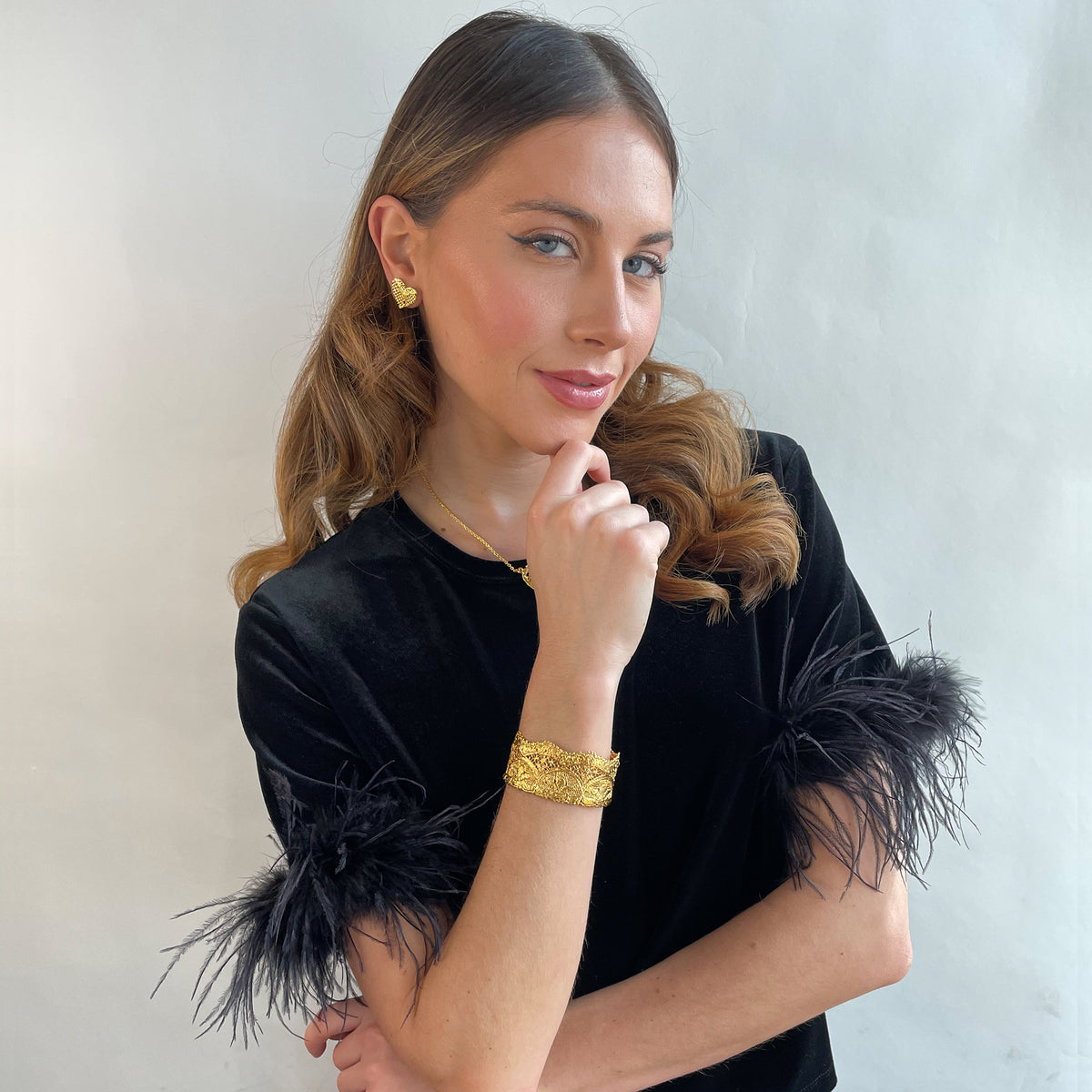 Phyllis fine lace cuff bracelet in dipped 24k gold on a model.