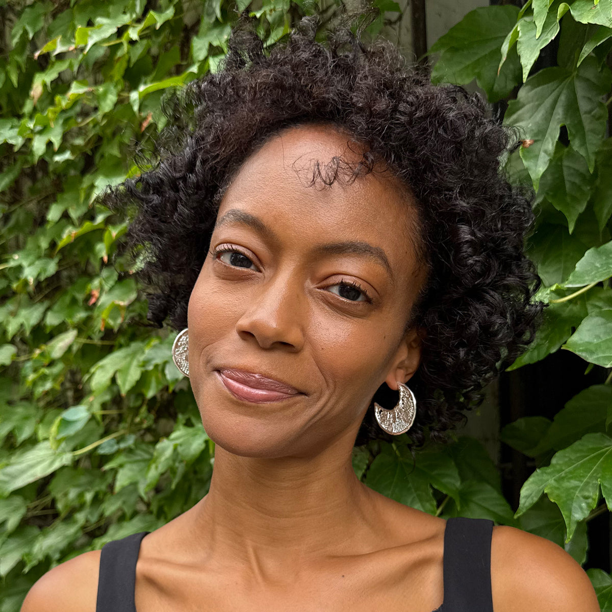 Model wearing Viviane Crescent Moon Hoop Lace Earrings in Sterling Silver.