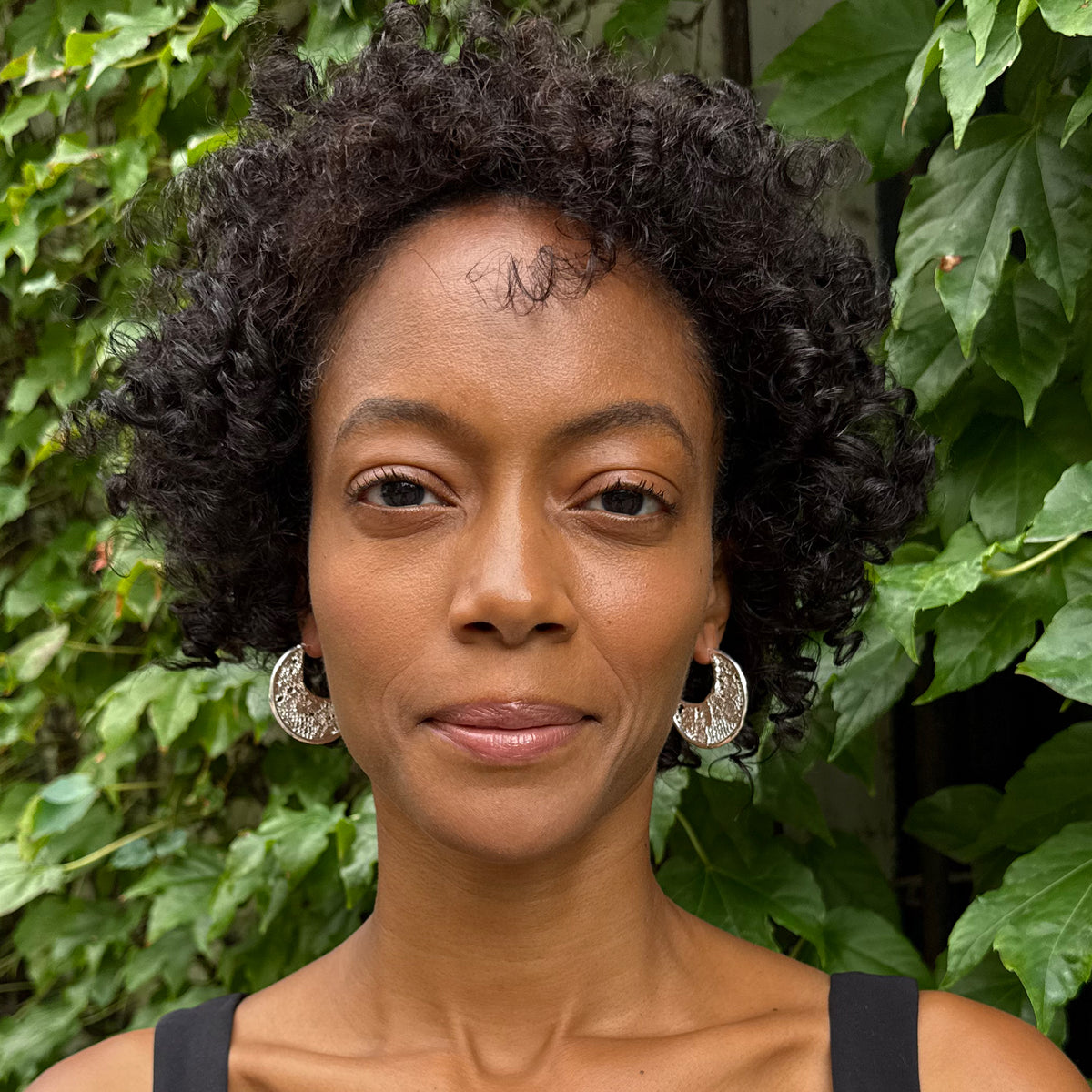 Model wearing Viviane Crescent Moon Hoop Lace Earrings in Sterling Silver.