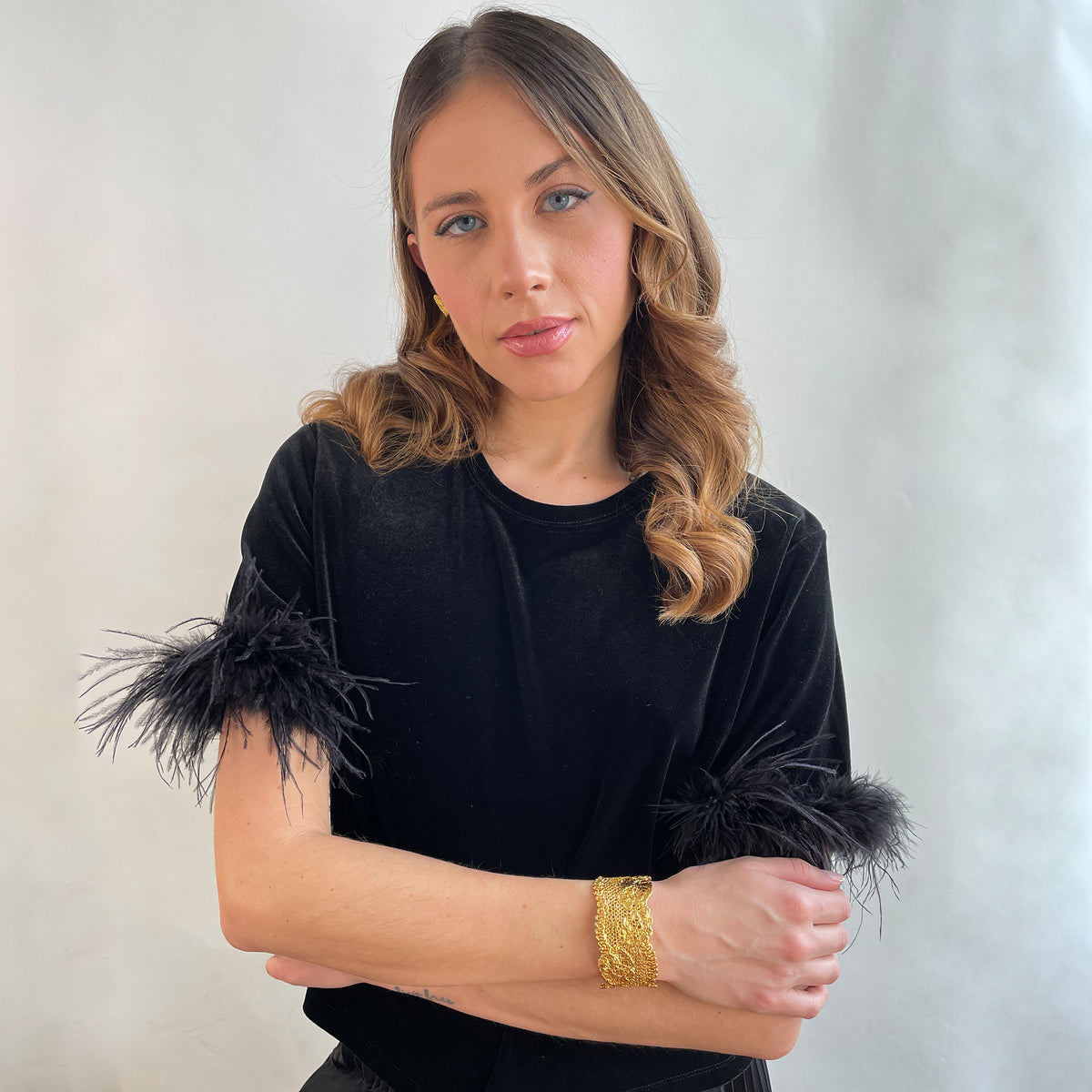 Donna lace cuff bracelet in 24k gold on a model.