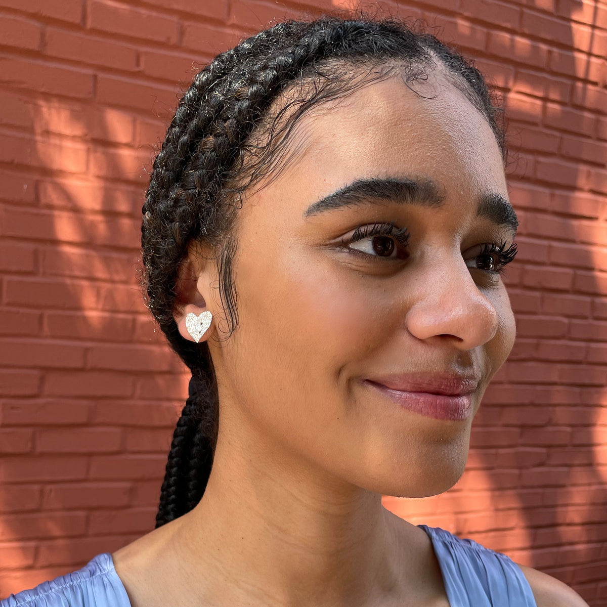 Lace heart stud earrings in sterling silver worn by model.