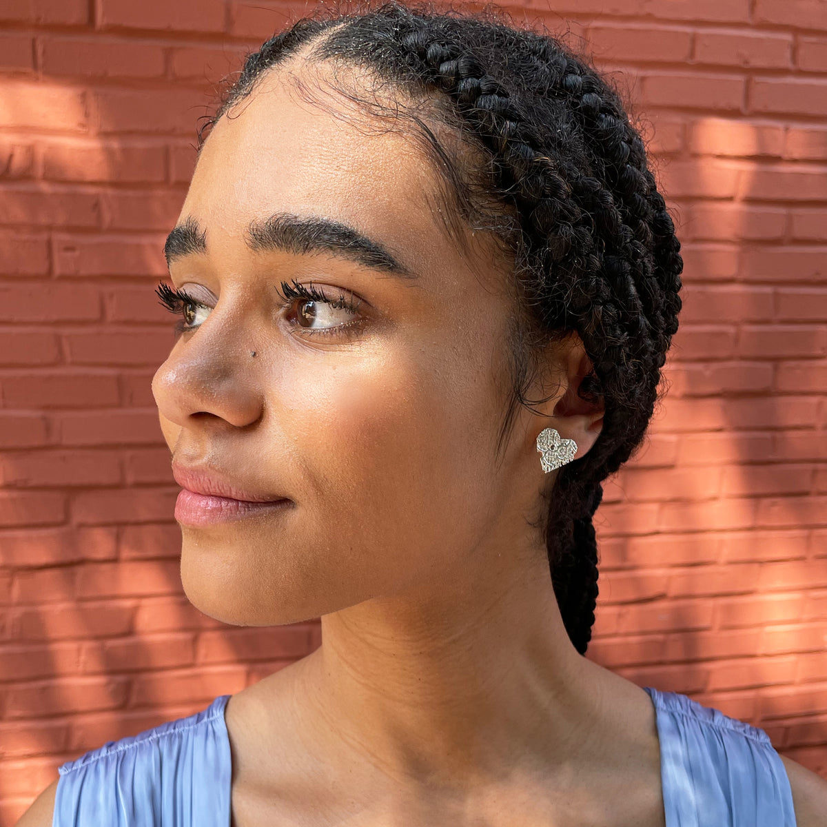 Lace heart stud earrings in sterling silver worn by model.