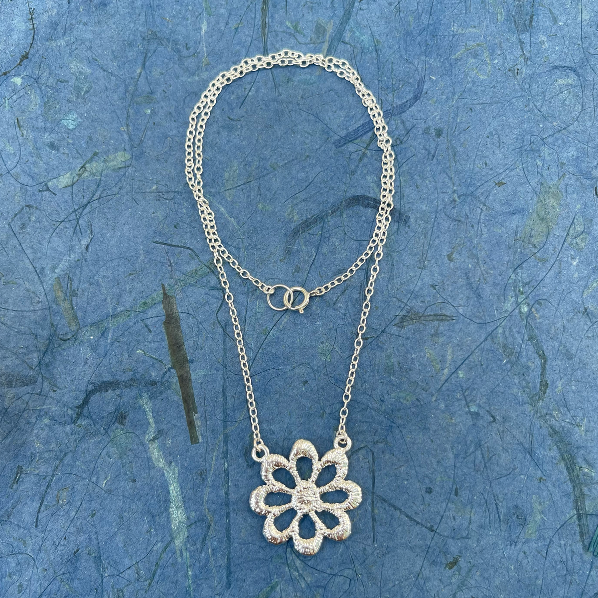 Lace flower necklace in sterling silver.