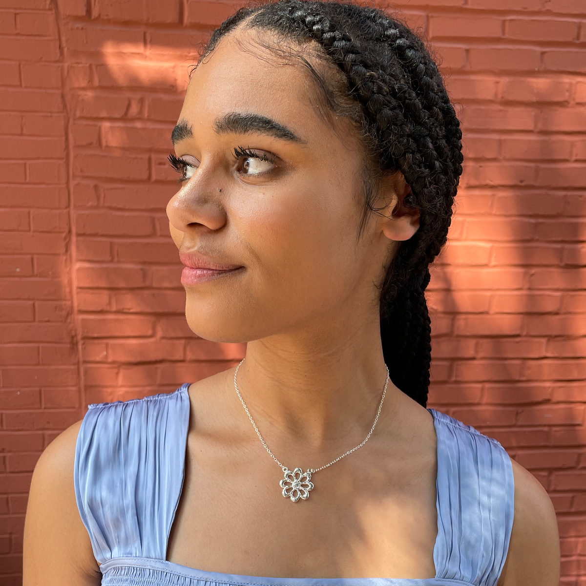 Lace flower necklace in sterling silver worn by a model.