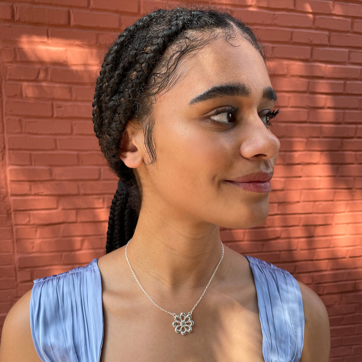 Lace flower necklace in sterling silver worn by a model.