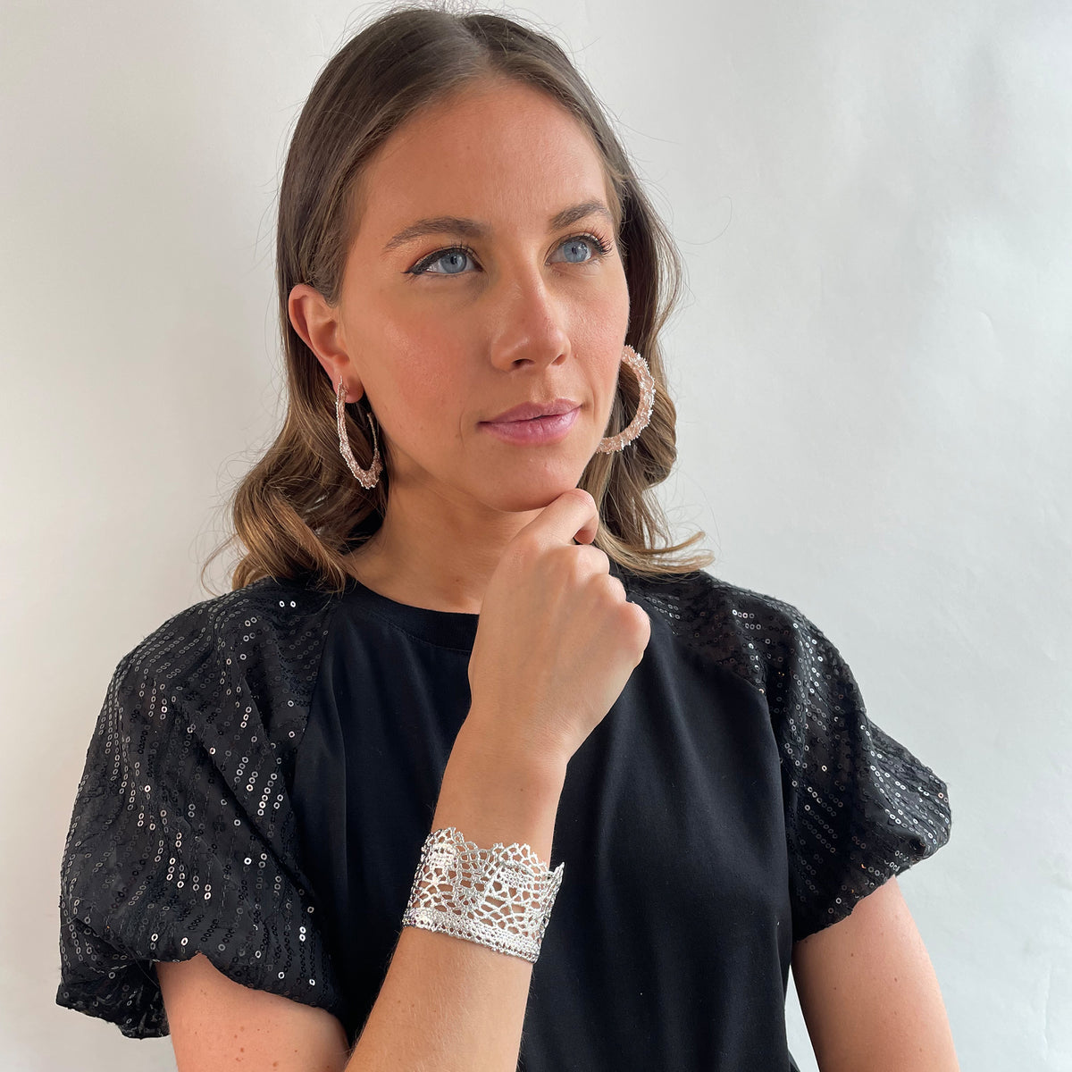 Intricate and exquisite lace cuff bracelet in sterling silver worn by a model.