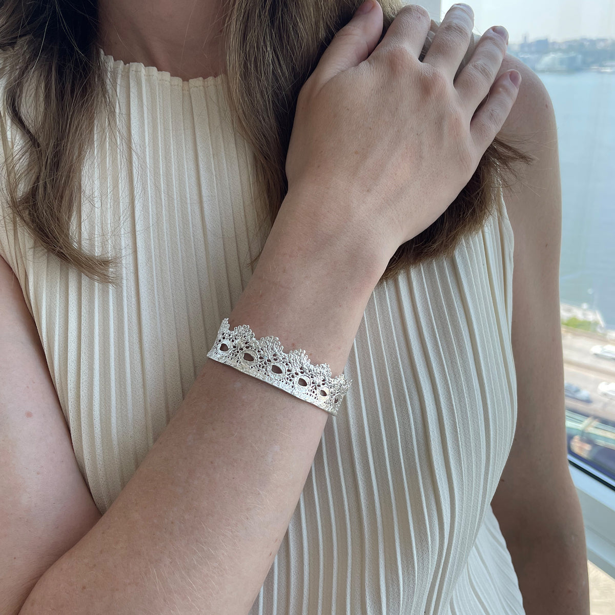 Chiara Fine lace cuff bracelet dipped in Sterling silver on a model.