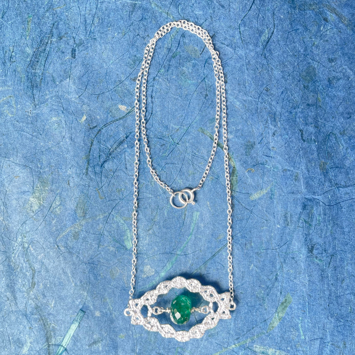 Chloe sterling silver lace pendant with an Emerald centerpiece.