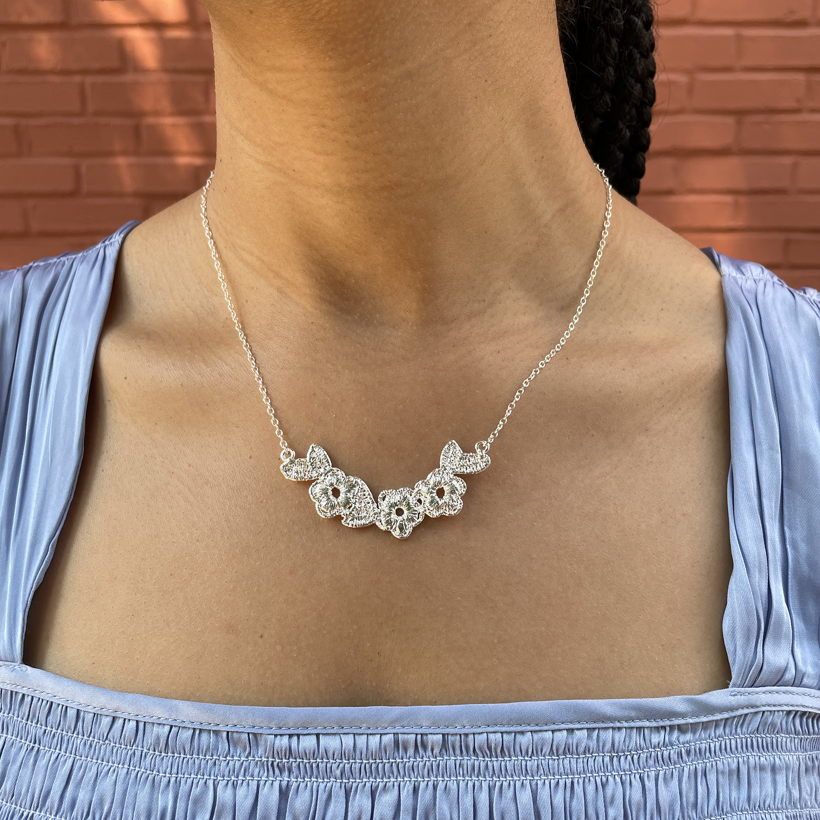 Lace flower garland necklace in sterling silver.