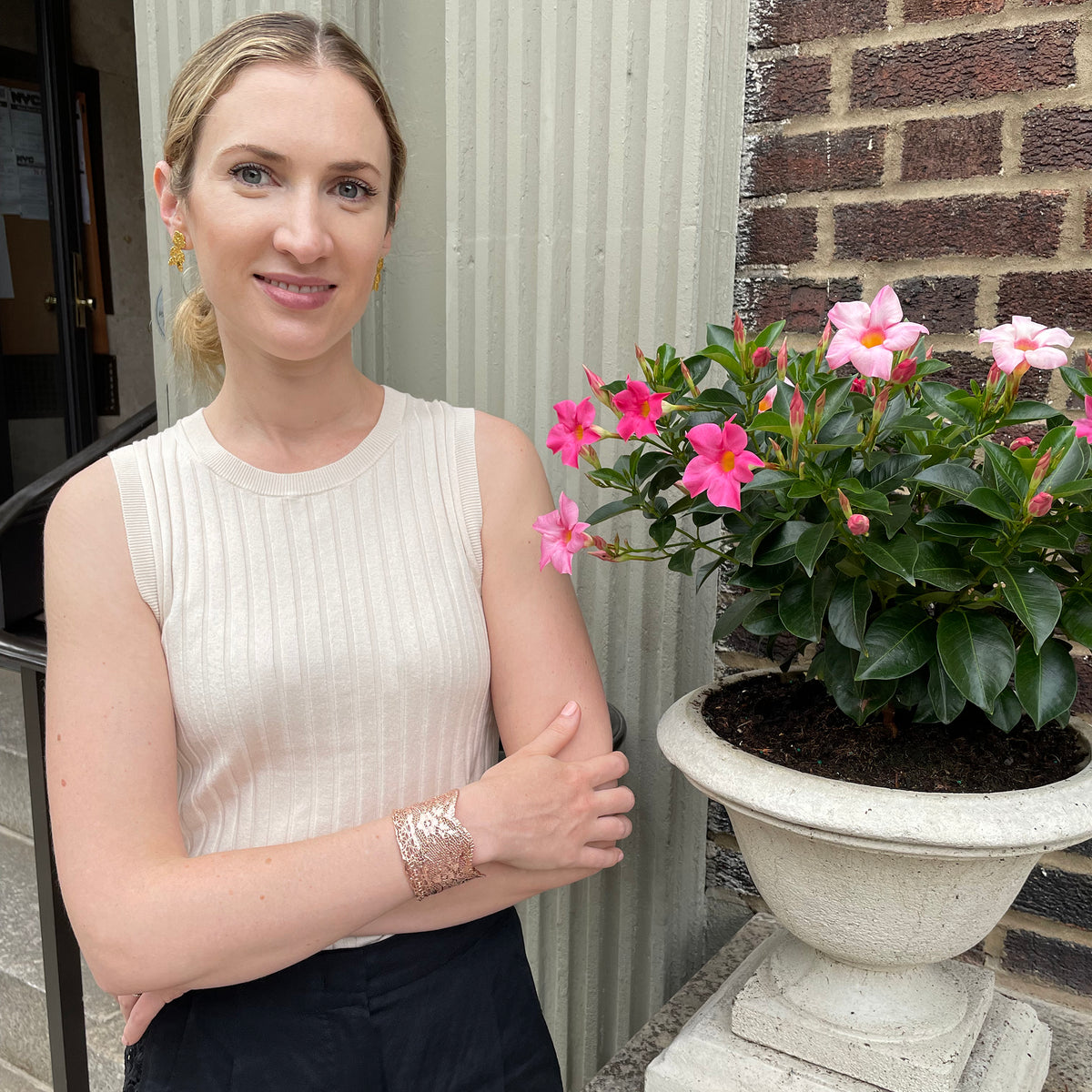 Intricate lace cuff bracelet in rose gold worn by model.