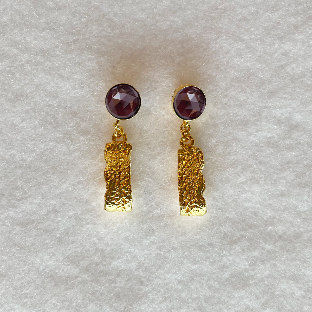 Ines lace earrings in 24k gold with faceted Garnets.