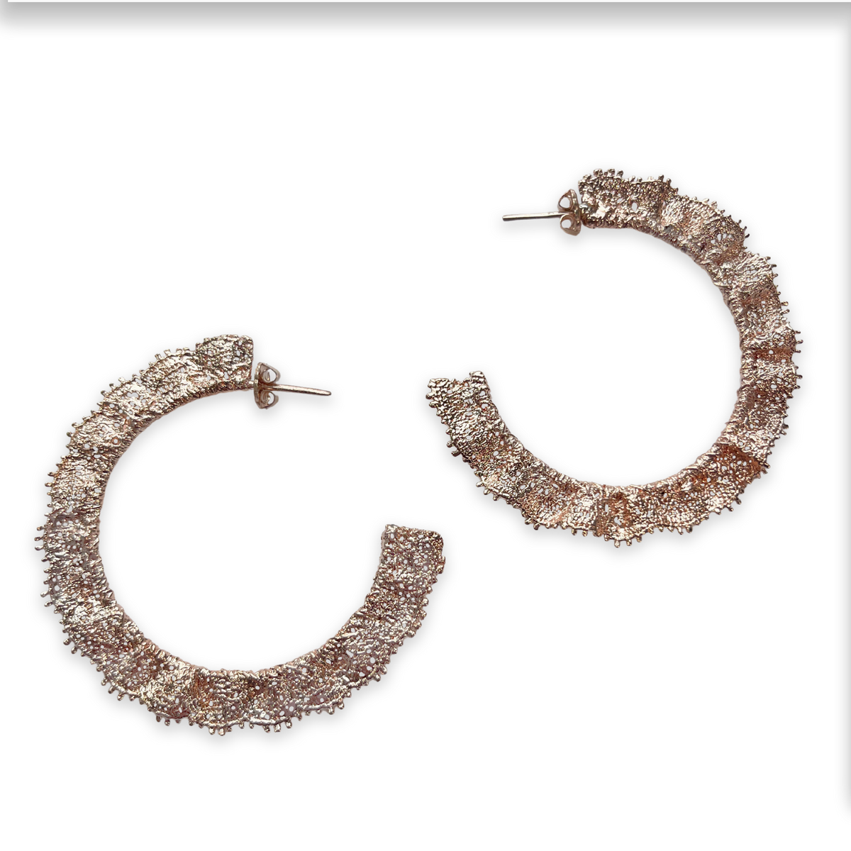 Jacqueline large lace hoop earrings in rose gold.