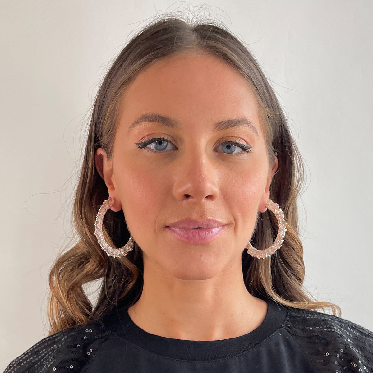 Jacqueline large lace hoop earrings in sterling silver on a model.