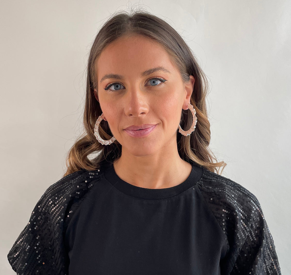 Jacqueline large lace hoop earrings in sterling silver on a model.