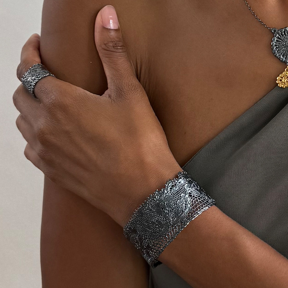 Model wearing Julie lace cuff bracelet in oxidized black sterling silver.