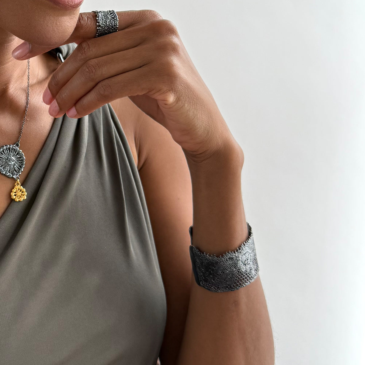 Model wearing Julie lace cuff bracelet in oxidized black sterling silver.