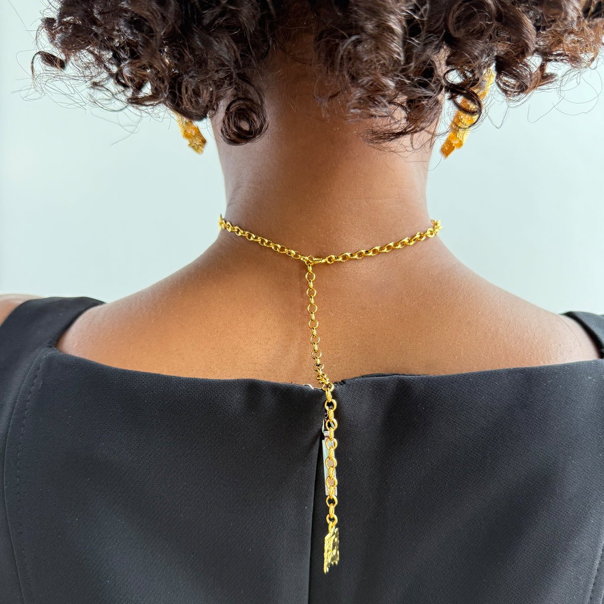 Back of model wearing Leontine lace choker necklace in 24k gold.