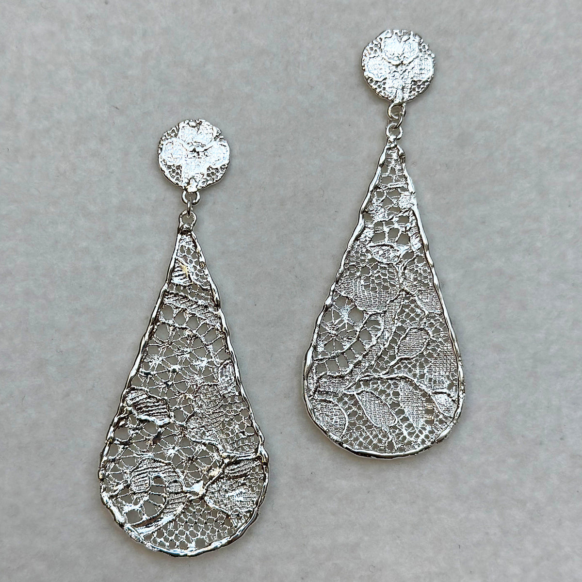 Lace tear drop earrings dipped in sterling silver, feather light. 