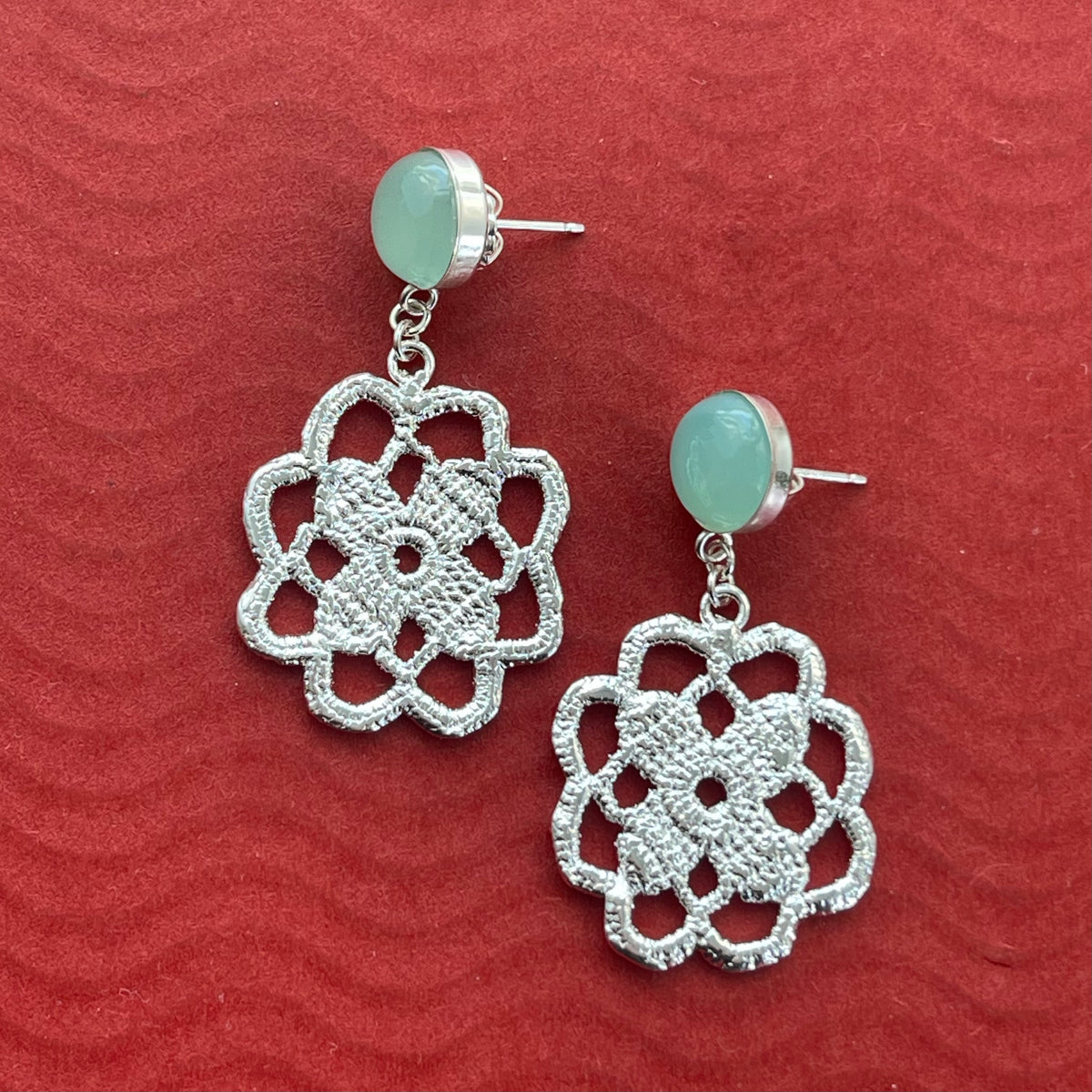 Lace flower earrings made from repurposed lace dipped in sterling silver with 10mm green Chalcedony cabochons.