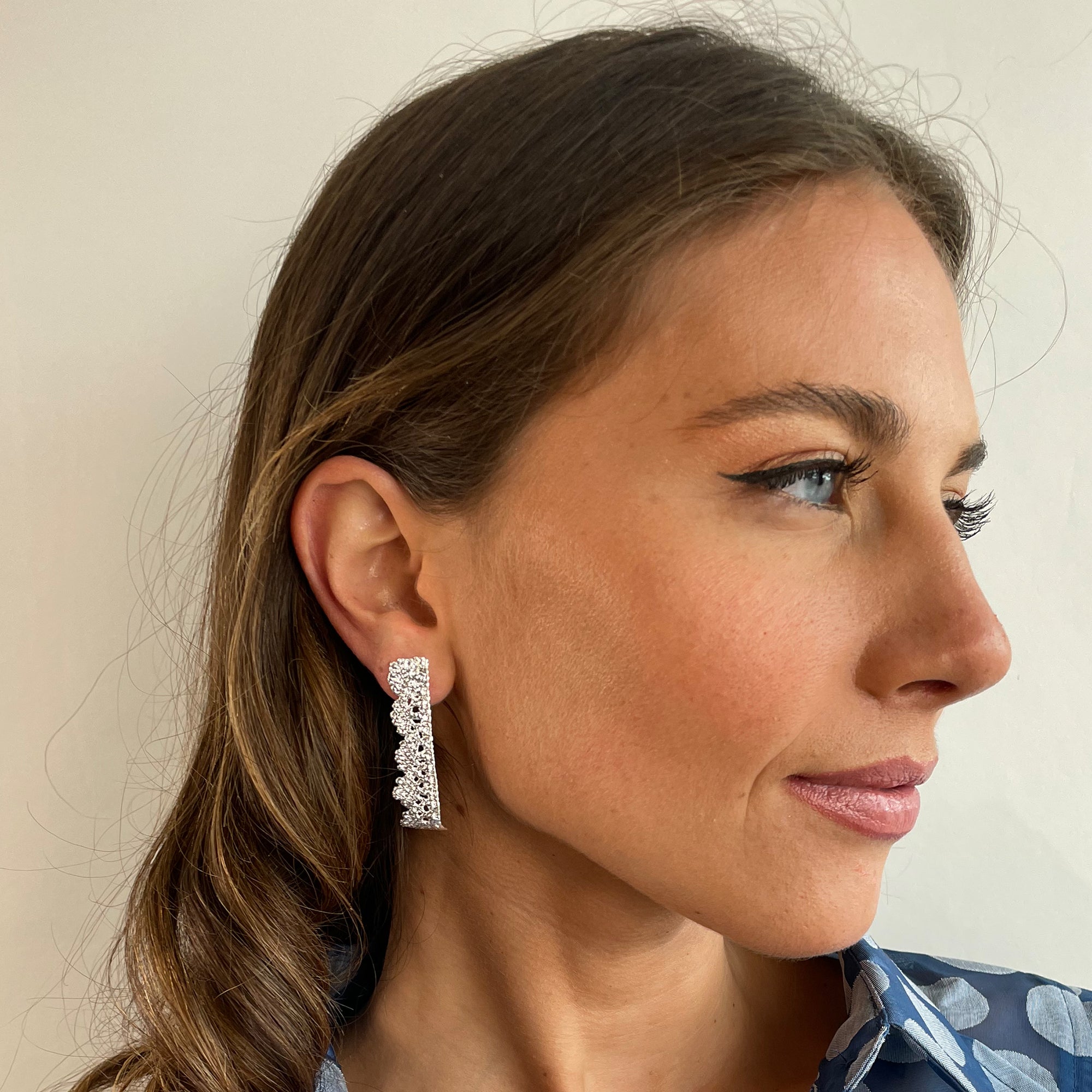 Lace stud earrings with scalloped edge dipped in sterling silver.
