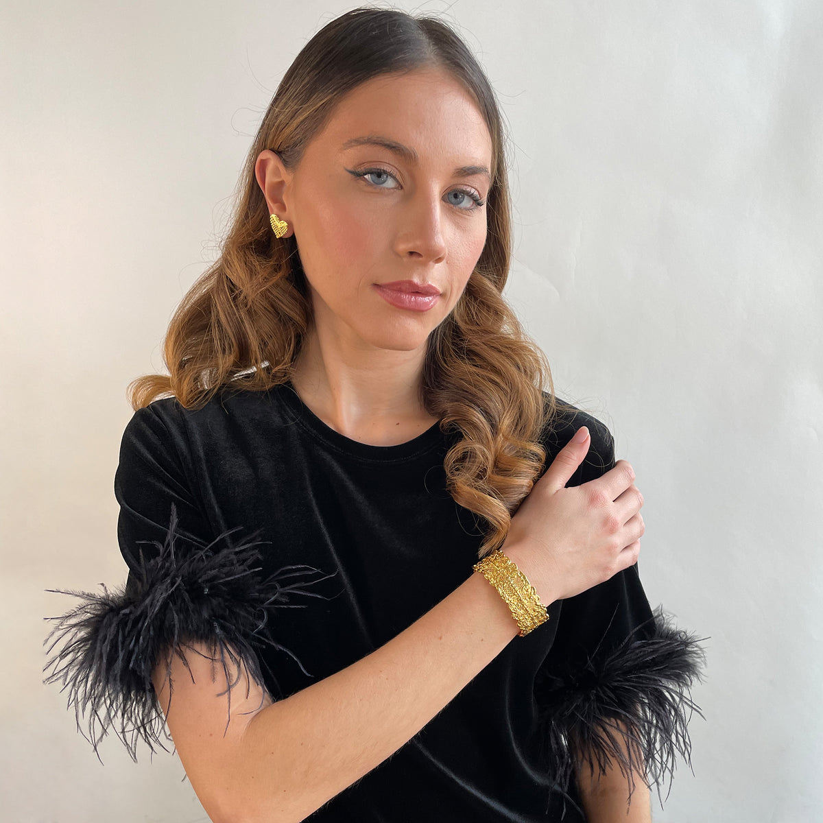 Marlene double scalloped lace bracelet in 24k gold worn by a model.