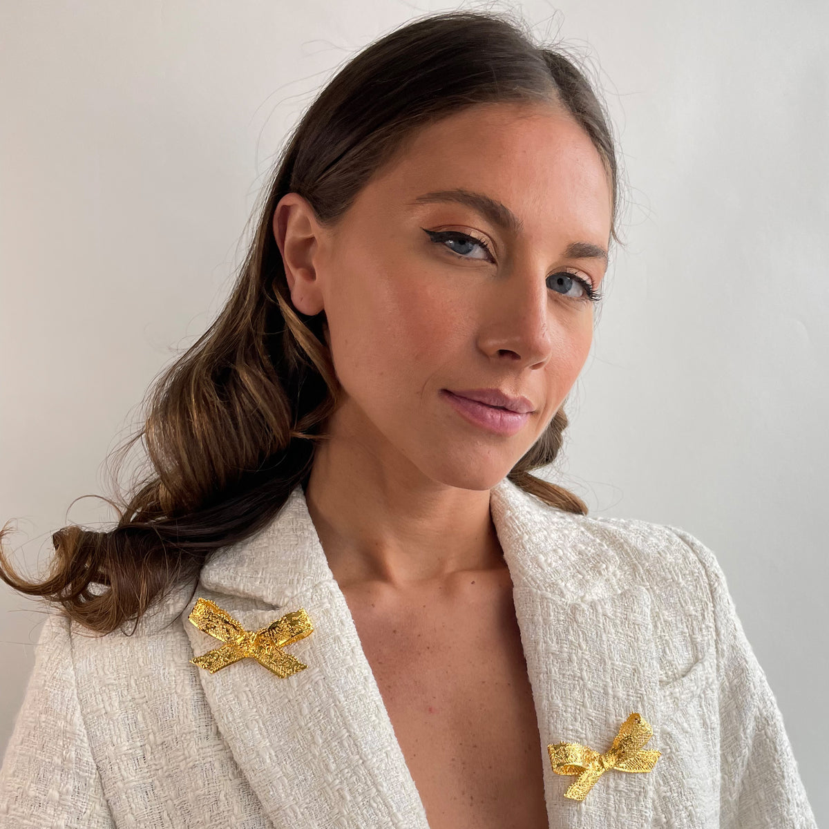 Bow Lace Brooch in 24k gold on a model.