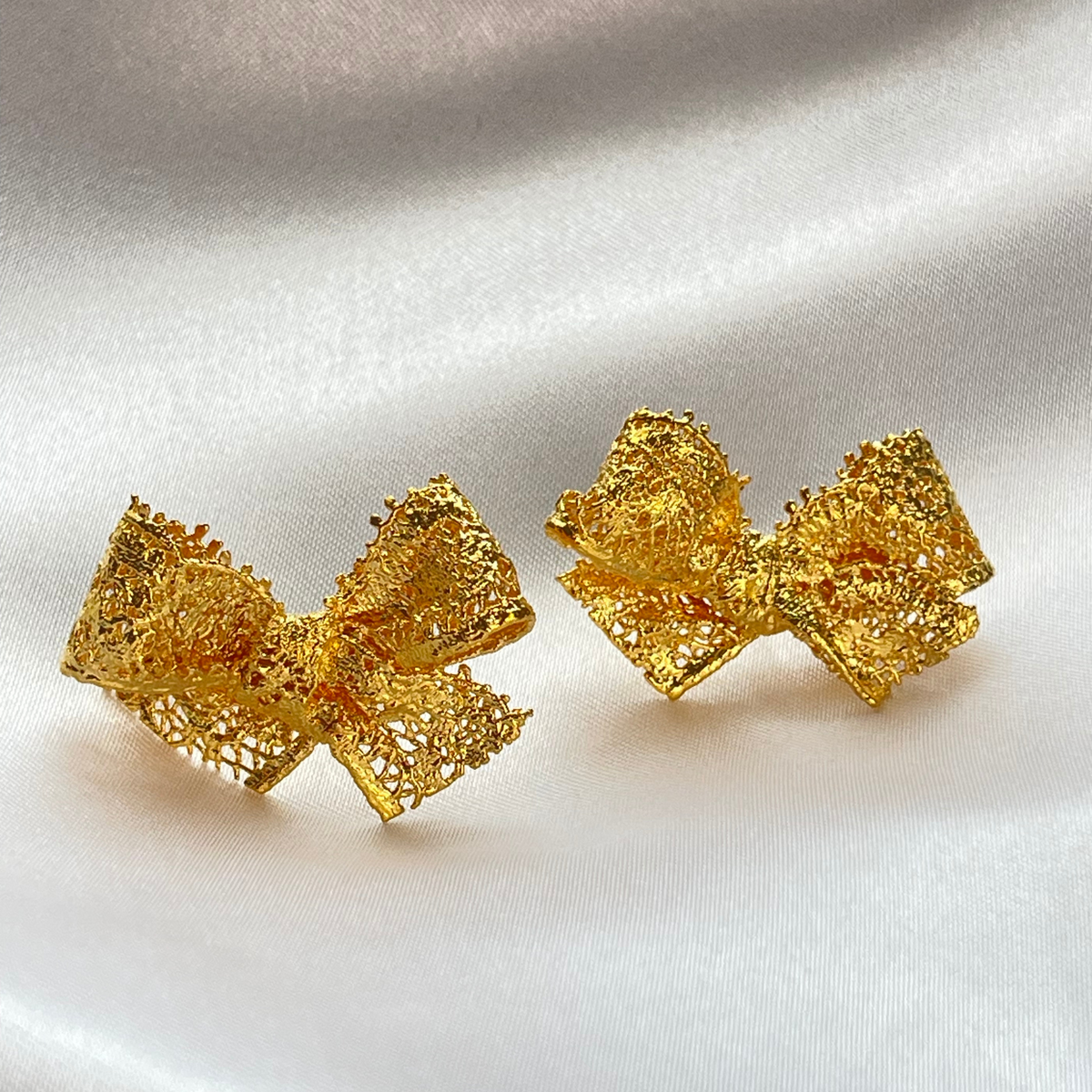Millie lace bow earrings in 24k gold.